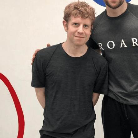 Josh Widdicombe standing with a ROAR personal trainer at ROAR Fitness London