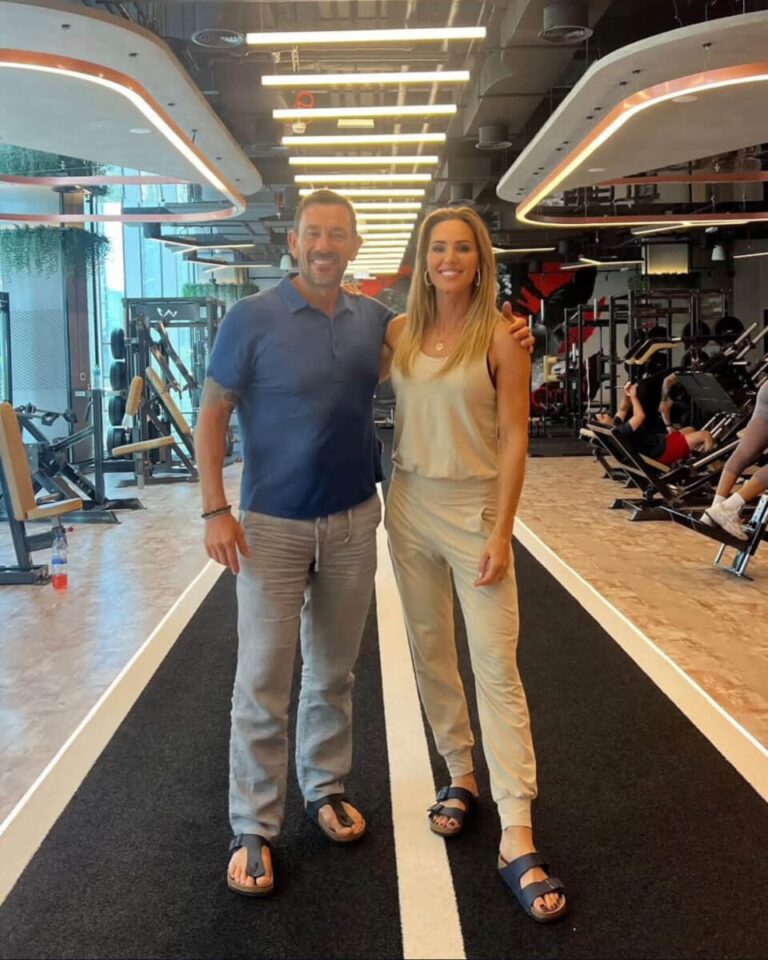 Ollie Ollerton standing with a ROAR trainer on the training track at ROAR Fitness