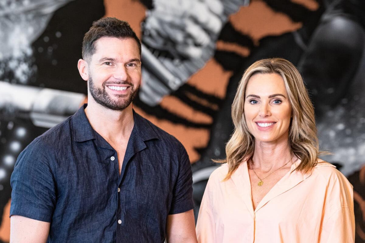ROAR Fitness founders Rich Phillipps and three-time Olympian Sarah Lindsay in front of the tiger mural at ROAR Fitness