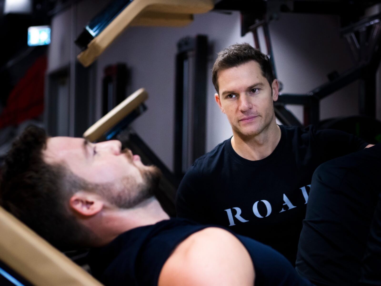 Rich Phillipps, Roar Fitness co-founder, watching a male client’s form during a one-to-one session