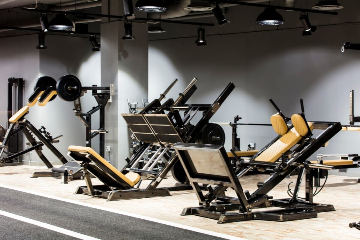 ROAR Fitness City of London gym with rows of plate-loaded resistance machines and a sprint track