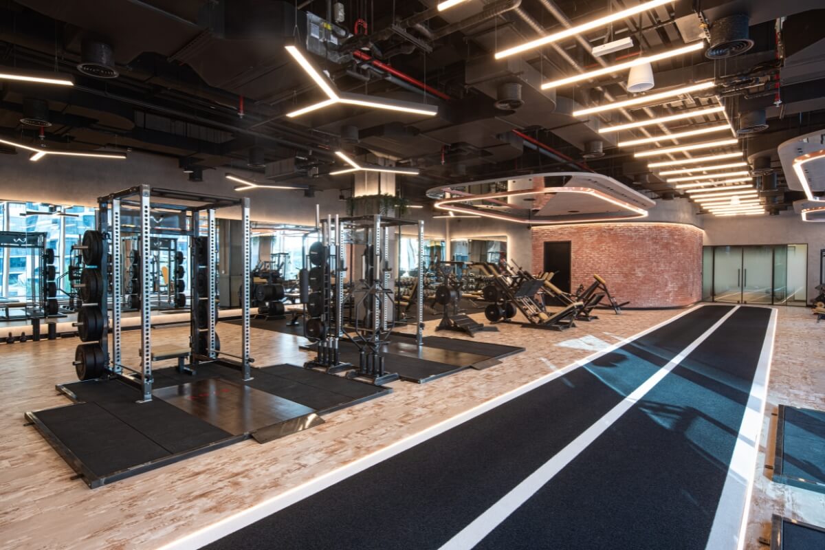 Squat racks and sled track in the strength training area at Roar Fitness Dubai