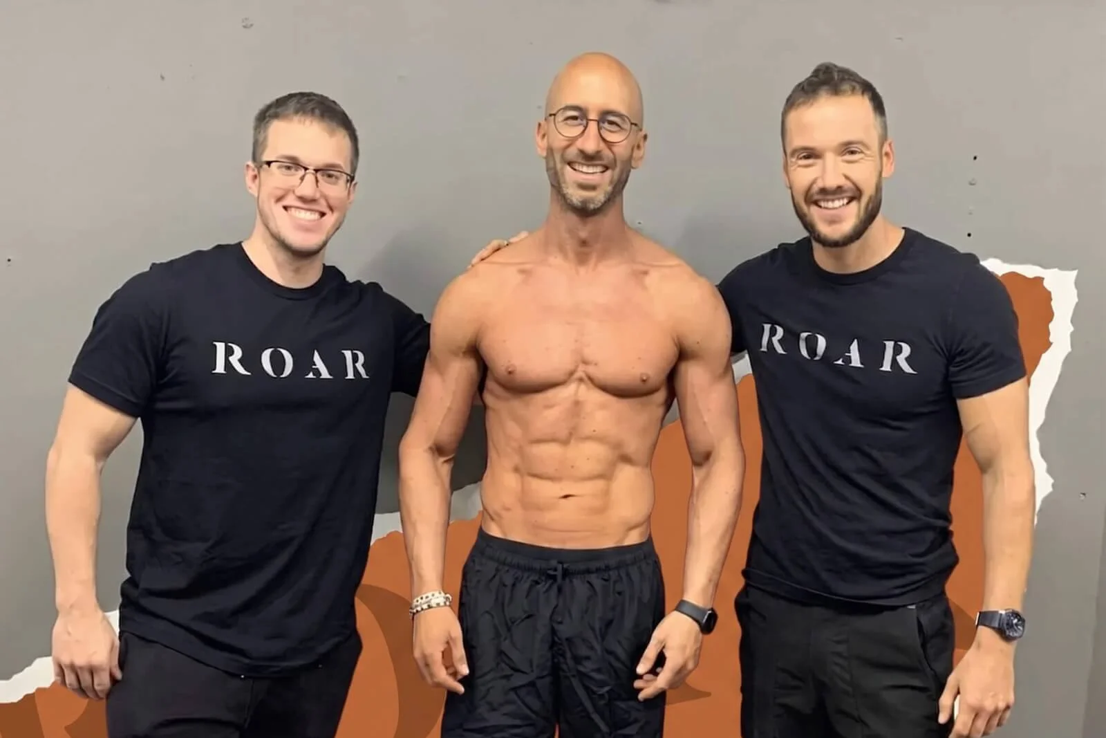 Two Roar Fitness personal trainers with a lean, muscular client at the end of his programme